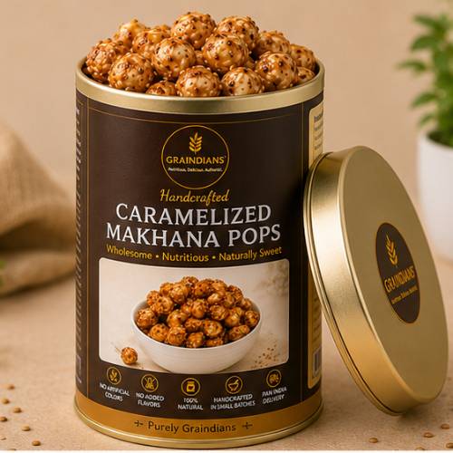 Open tin of Graindians Caramelized Makhana Pops filled with crunchy caramel-coated fox nuts