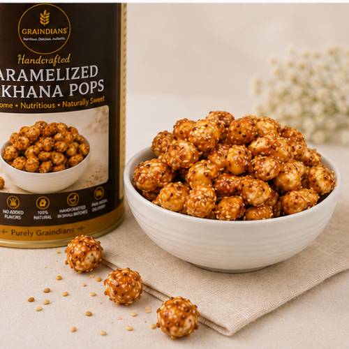 Bowl of Graindians Caramelized Makhana Pops made with roasted fox nuts, jaggery, ghee, and sesame seeds